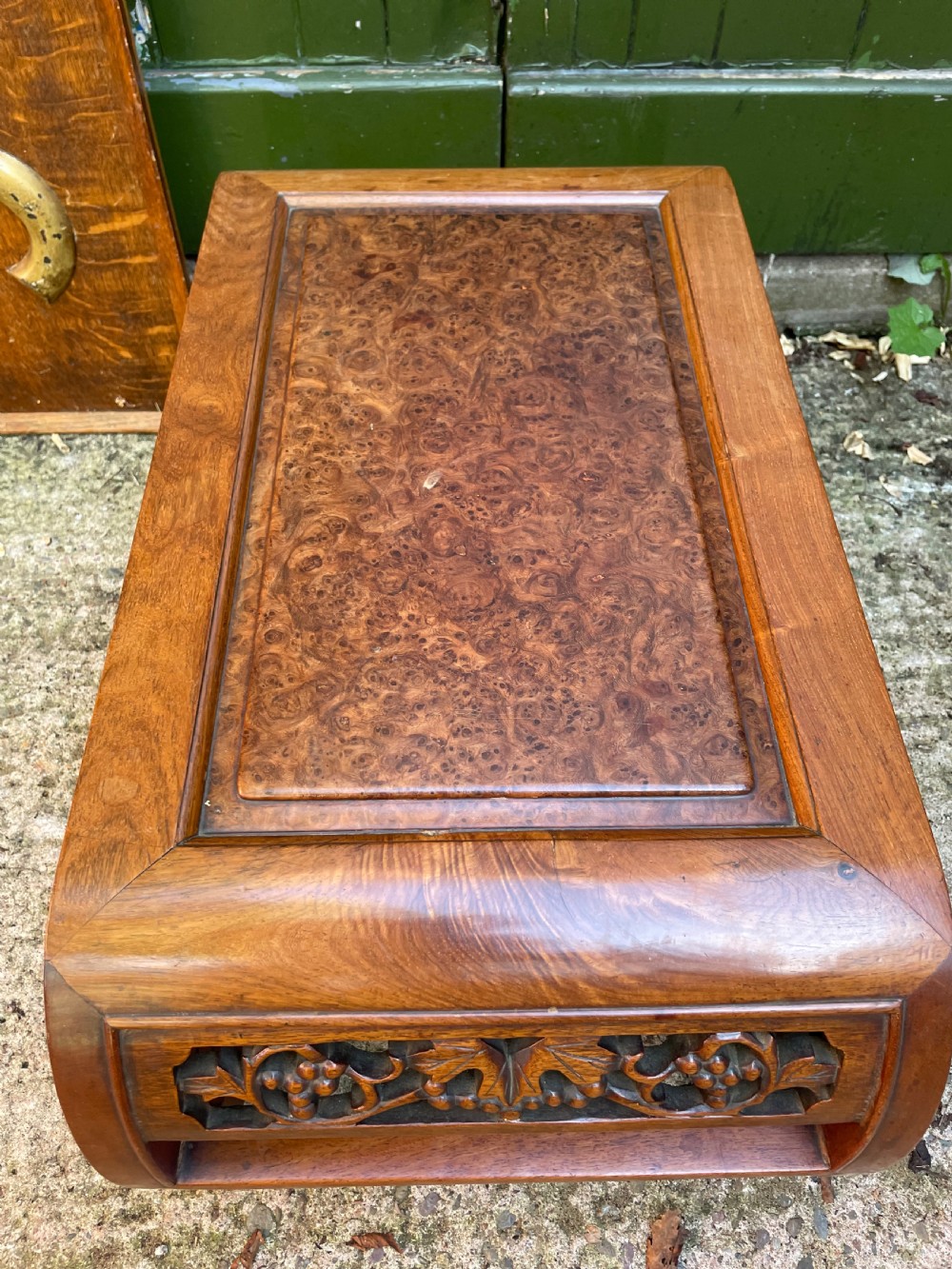 A low carved dark hardwood Chinese Kang table featuring scroll feet and a pierced floral apron. View VII