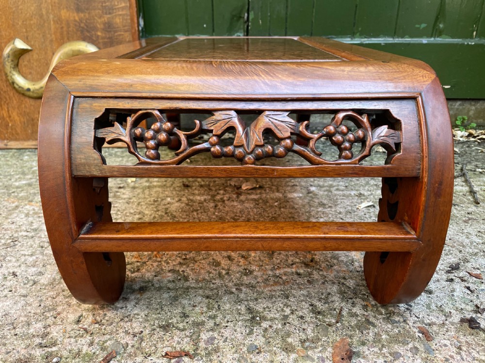 A low carved dark hardwood Chinese Kang table featuring scroll feet and a pierced floral apron. View VIII
