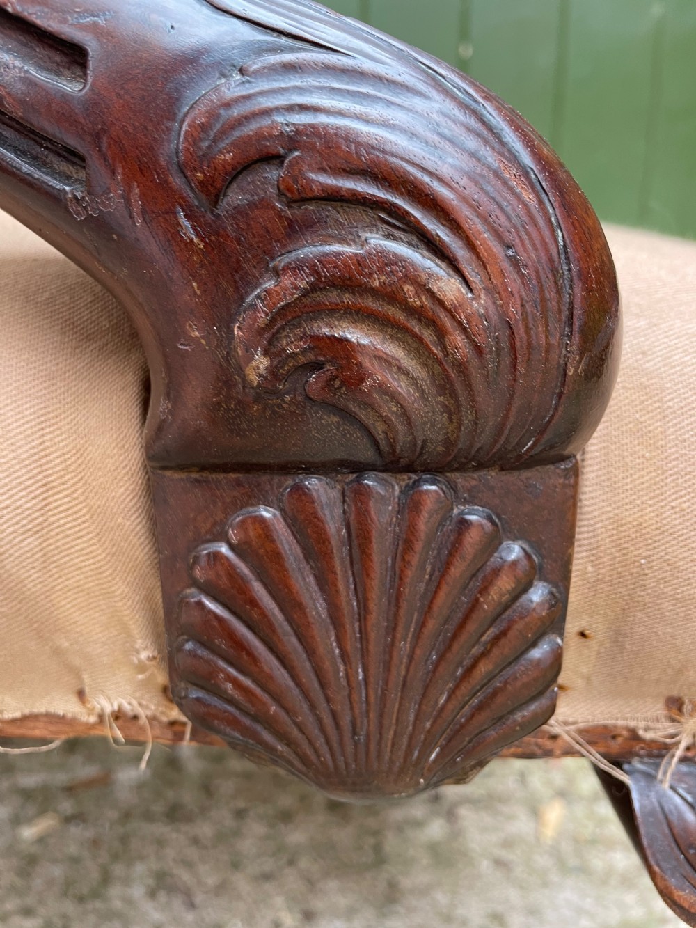 A mid-nineteenth-century carved mahogany Gainsborough armchair upholstered in neutral fabric with carved cabriole legs and claw and ball feet. View V