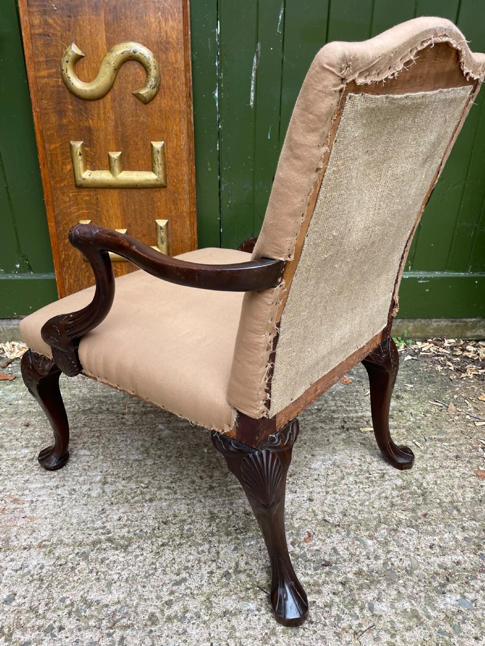 A mid-nineteenth-century carved mahogany Gainsborough armchair upholstered in neutral fabric with carved cabriole legs and claw and ball feet. View XII