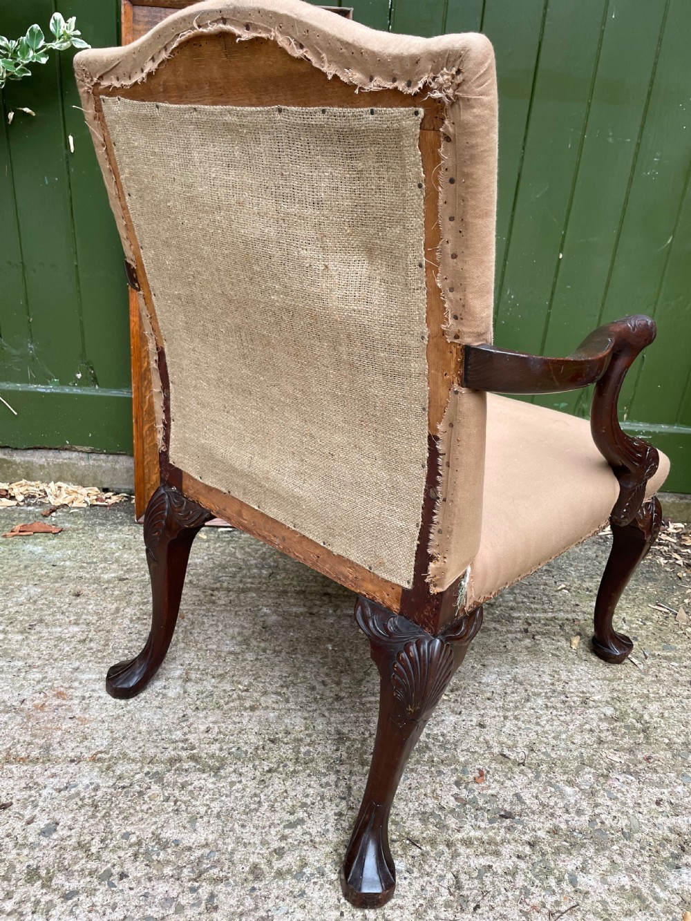 A mid-nineteenth-century carved mahogany Gainsborough armchair upholstered in neutral fabric with carved cabriole legs and claw and ball feet. View XIII