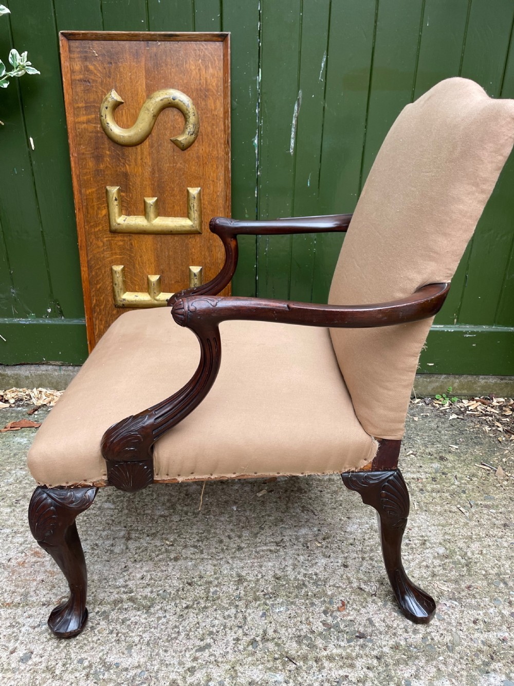 A mid-nineteenth-century carved mahogany Gainsborough armchair upholstered in neutral fabric with carved cabriole legs and claw and ball feet. View XV