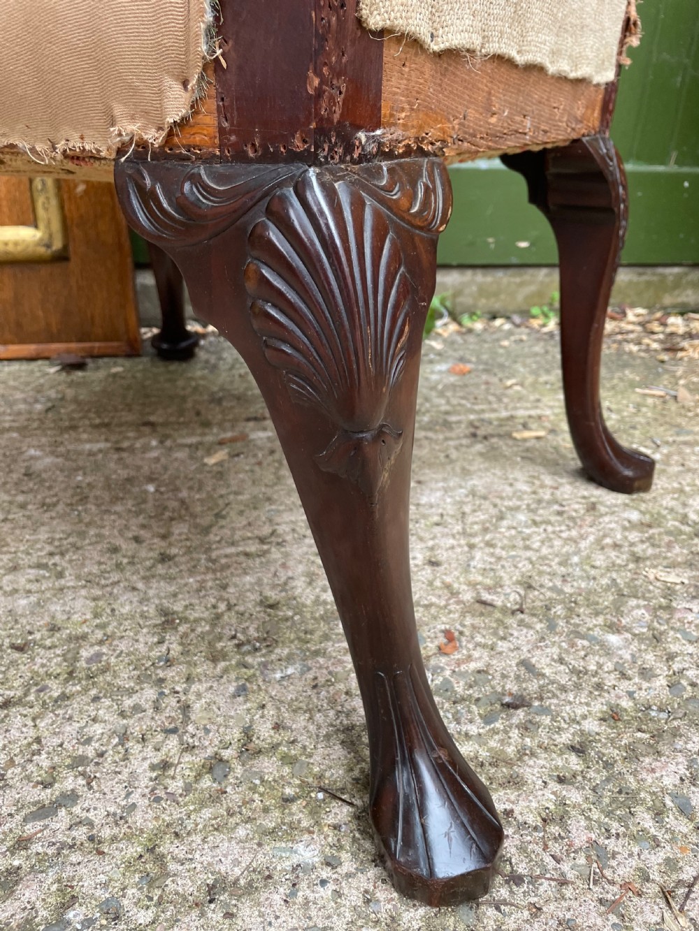 A mid-nineteenth-century carved mahogany Gainsborough armchair upholstered in neutral fabric with carved cabriole legs and claw and ball feet. View XVI