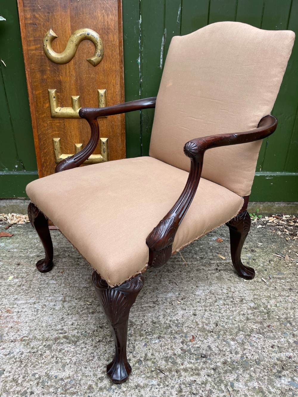 A mid-nineteenth-century carved mahogany Gainsborough armchair upholstered in neutral fabric with carved cabriole legs and claw and ball feet. View XVII
