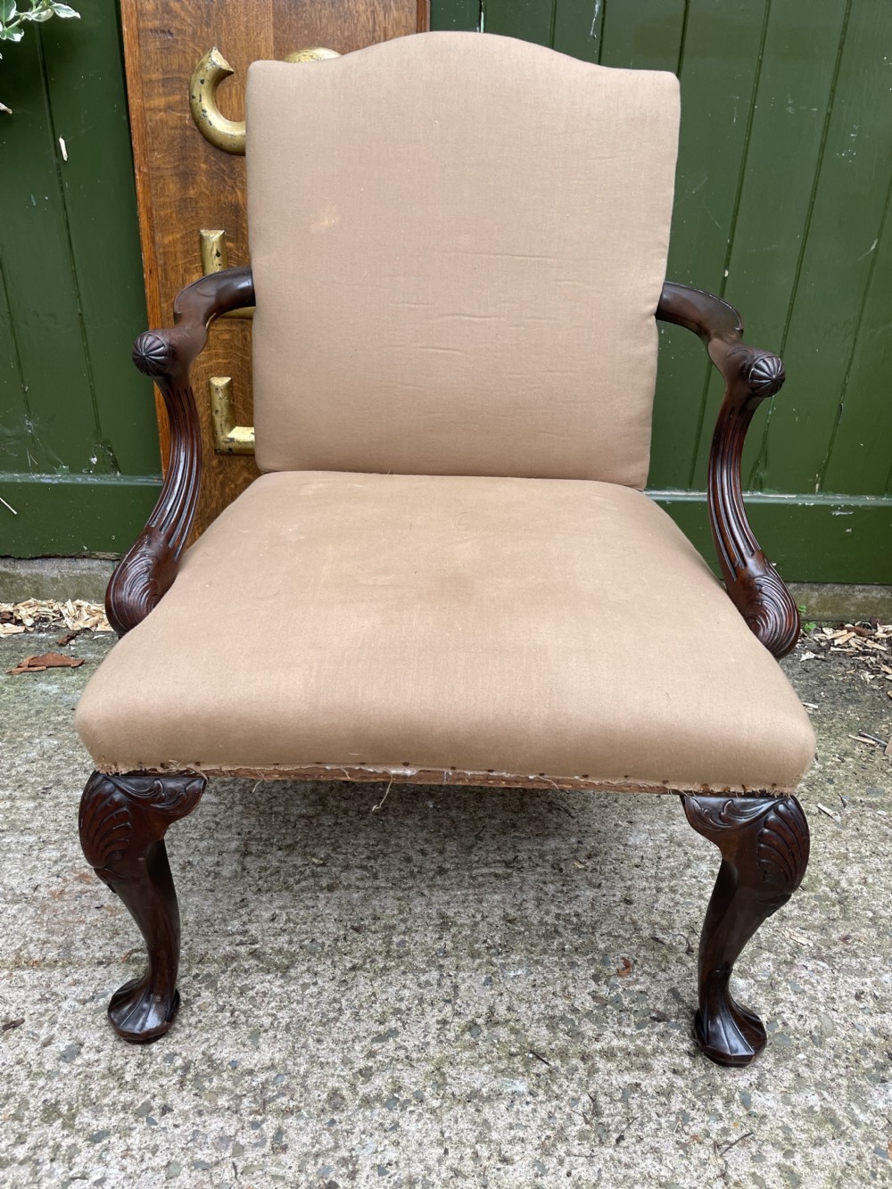 A mid-nineteenth-century carved mahogany Gainsborough armchair upholstered in neutral fabric with carved cabriole legs and claw and ball feet. View XX