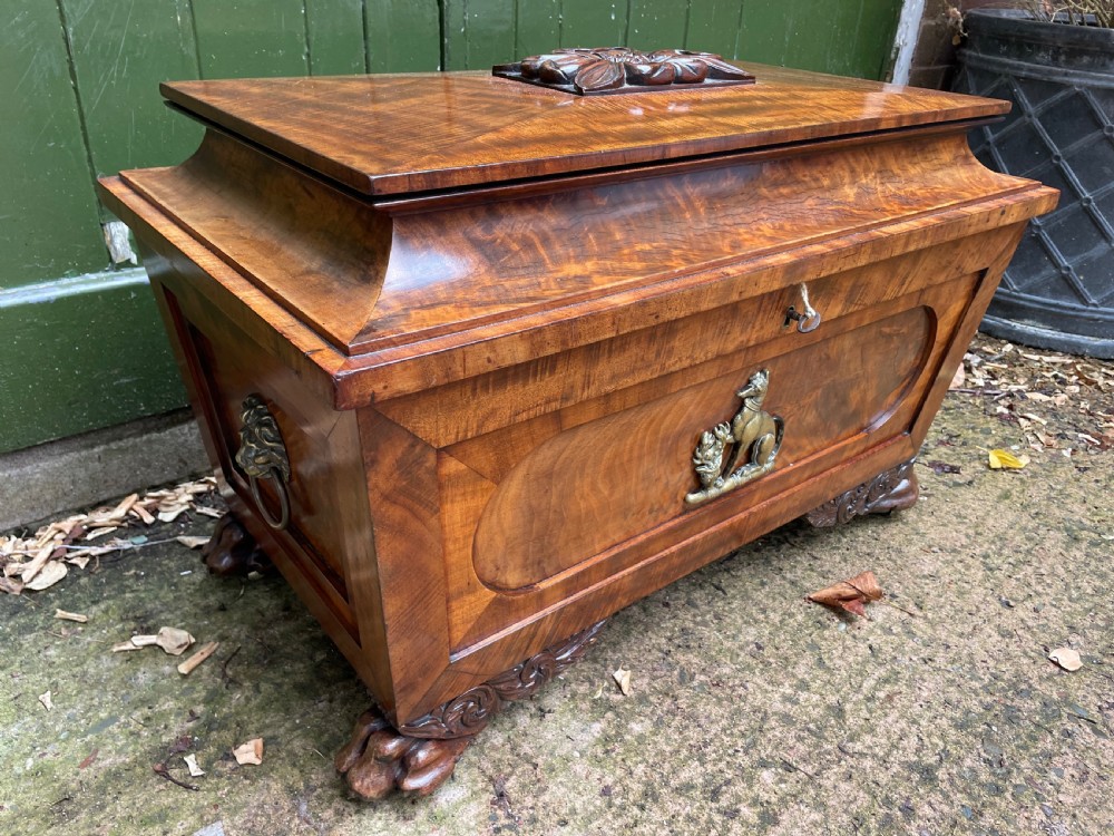 Early C19th Regency period brass-mounted mahogany cellarette or wine-cooler of classical sarcophagus form with a noble armorial . View III