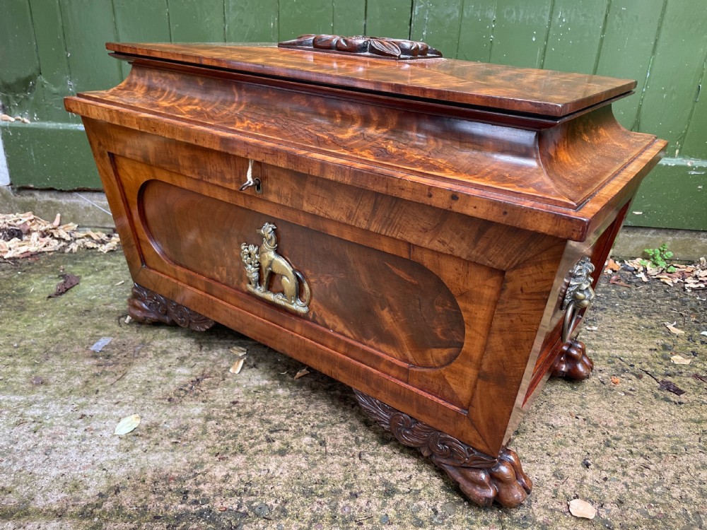 Early C19th Regency period brass-mounted mahogany cellarette or wine-cooler of classical sarcophagus form with a noble armorial . View X