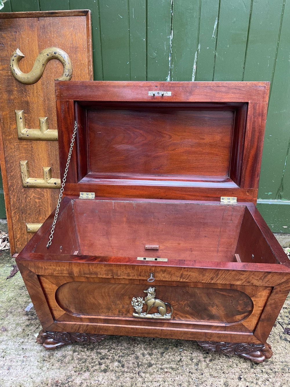 Early C19th Regency period brass-mounted mahogany cellarette or wine-cooler of classical sarcophagus form with a noble armorial . View XVII