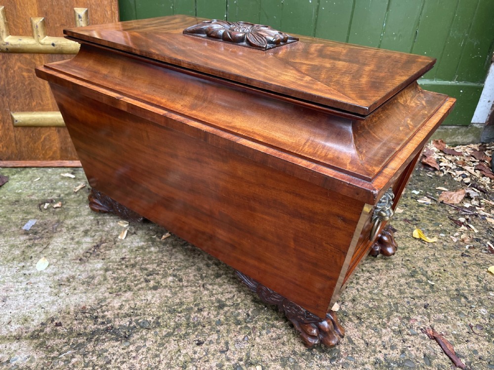 Early C19th Regency period brass-mounted mahogany cellarette or wine-cooler of classical sarcophagus form with a noble armorial . View XIX
