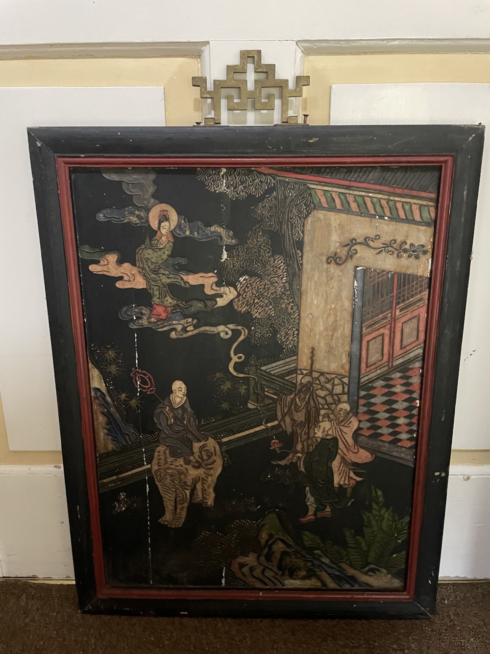 A set of four rectangular black lacquer panels framed in dark wood with red inner borders, depicting carved Chinese figurative scenes in landscape settings. View III