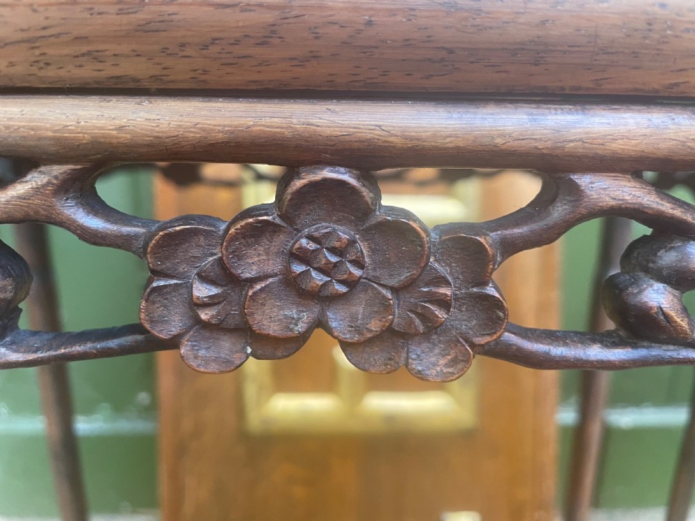 A set of four late nineteenth-century Chinese carved hardwood nesting tables stacked in size order with carved floral aprons. View VIII