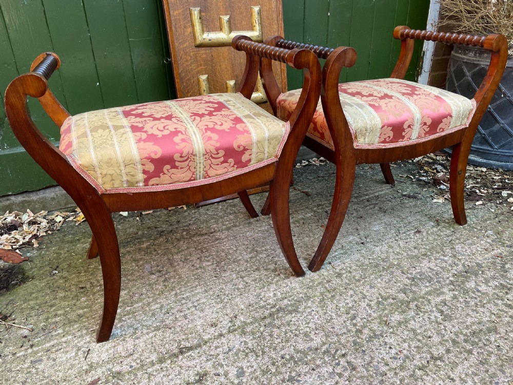 Set of four early nineteenth-century mahogany dressing stools with raised spiral-turned handles, swept legs, and red and gold patterned damask seats. View V