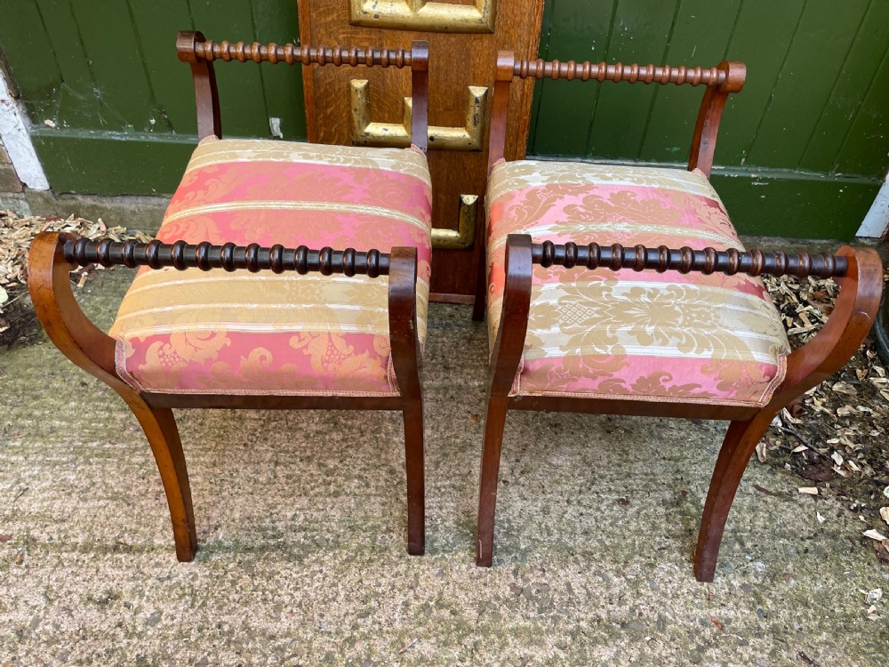 Set of four early nineteenth-century mahogany dressing stools with raised spiral-turned handles, swept legs, and red and gold patterned damask seats. View VI