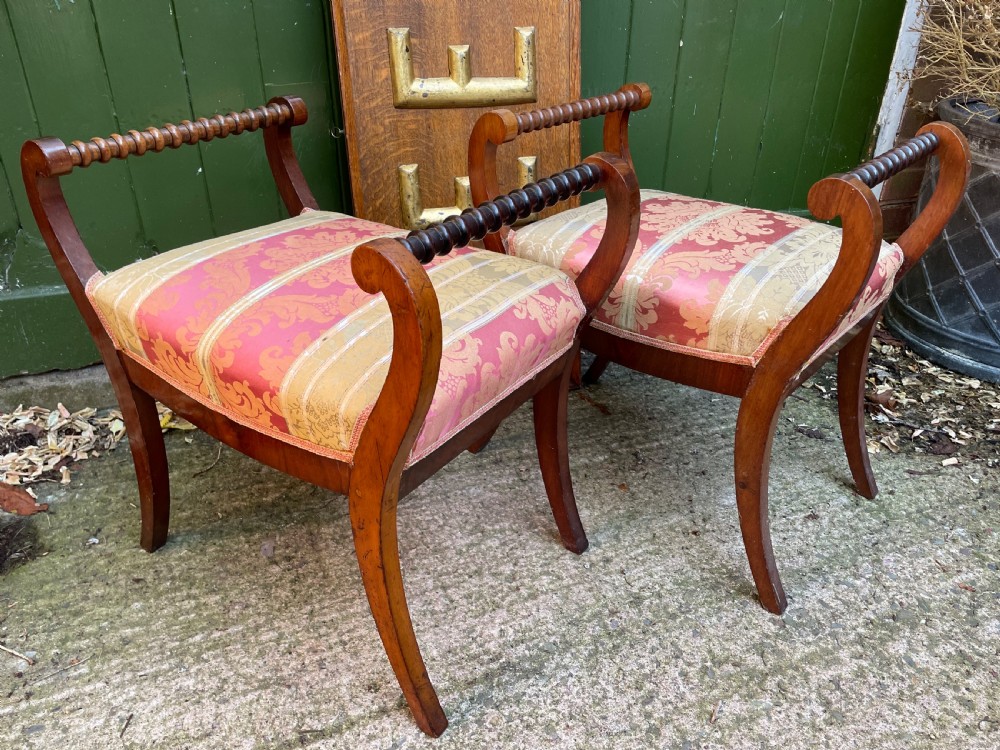 Set of four early nineteenth-century mahogany dressing stools with raised spiral-turned handles, swept legs, and red and gold patterned damask seats. View VII