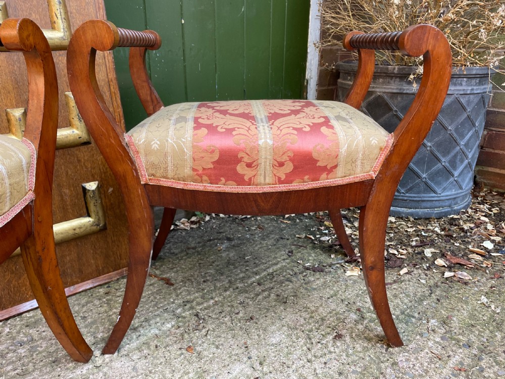 Set of four early nineteenth-century mahogany dressing stools with raised spiral-turned handles, swept legs, and red and gold patterned damask seats. View IX