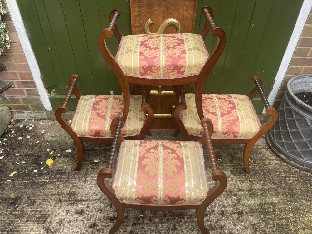 Set of four early nineteenth-century mahogany dressing stools with raised spiral-turned handles, swept legs, and red and gold patterned damask seats. View II