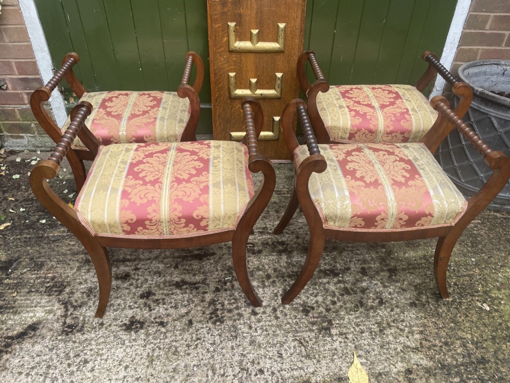 Set of four early nineteenth-century mahogany dressing stools with raised spiral-turned handles, swept legs, and red and gold patterned damask seats. View III