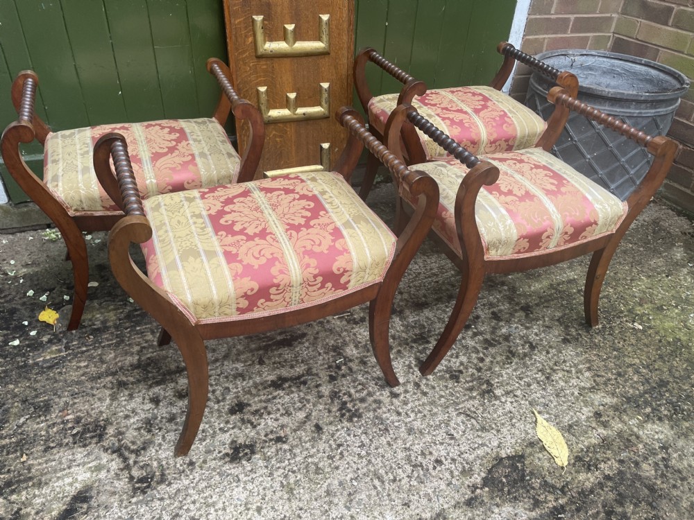 Set of four early nineteenth-century mahogany dressing stools with raised spiral-turned handles, swept legs, and red and gold patterned damask seats. View XVIII