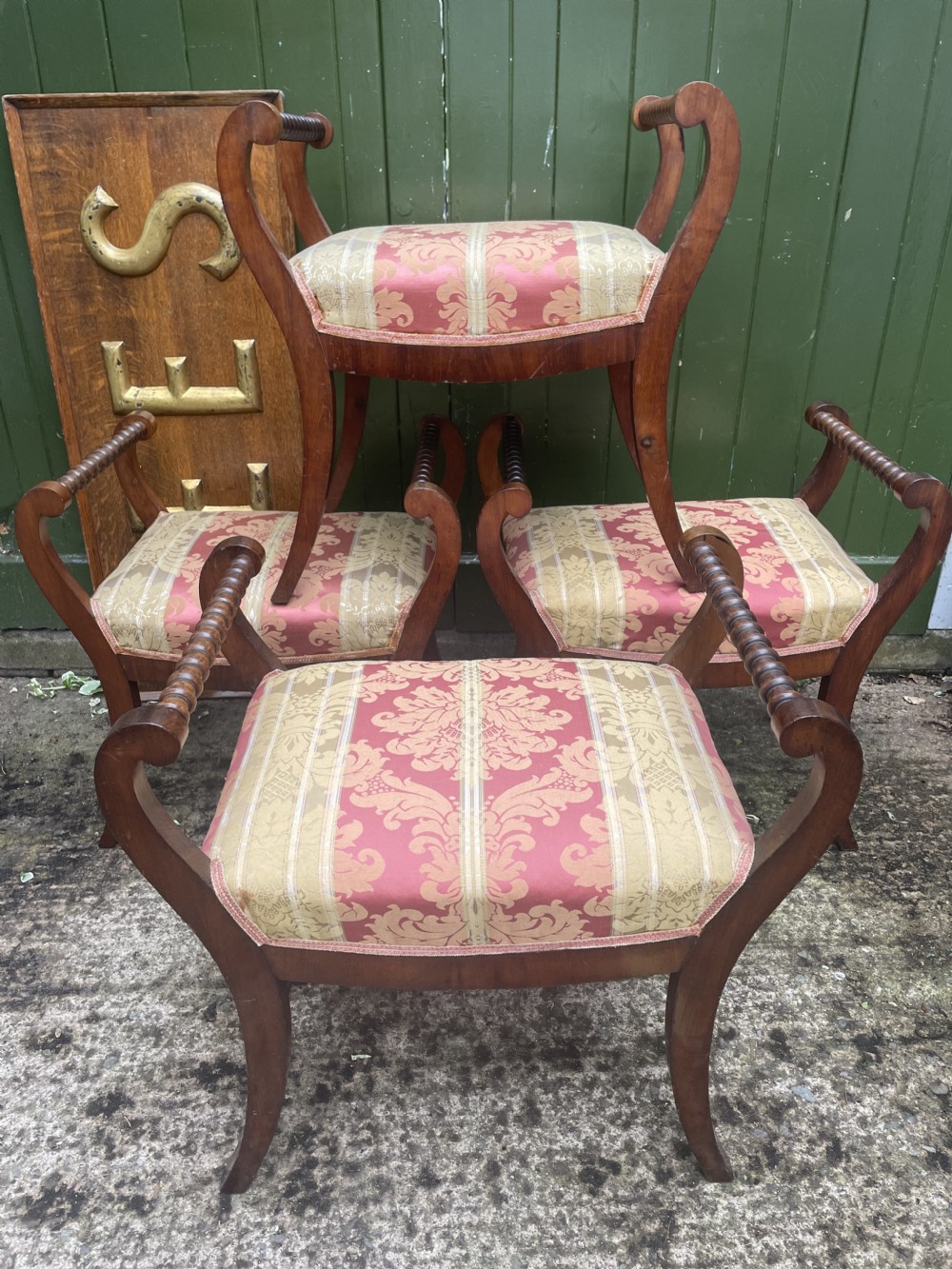 Set of four early nineteenth-century mahogany dressing stools with raised spiral-turned handles, swept legs, and red and gold patterned damask seats. View XIX