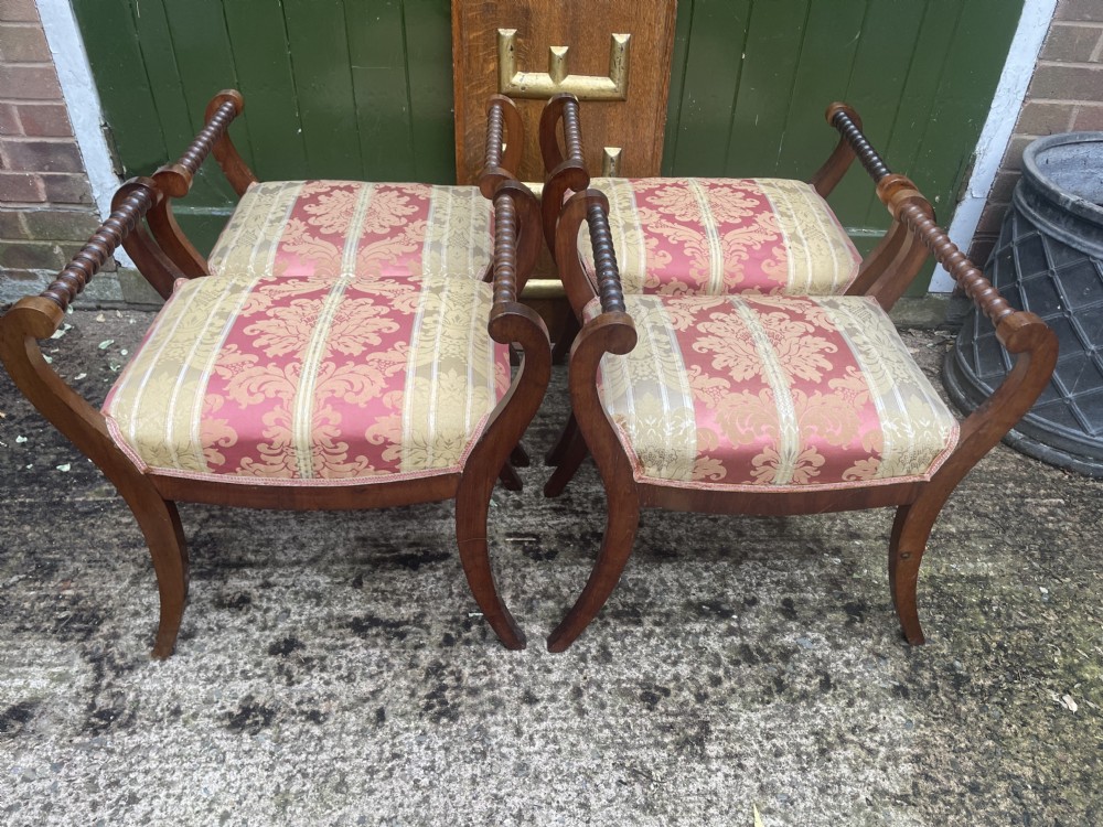 Set of four early nineteenth-century mahogany dressing stools with raised spiral-turned handles, swept legs, and red and gold patterned damask seats. View XX