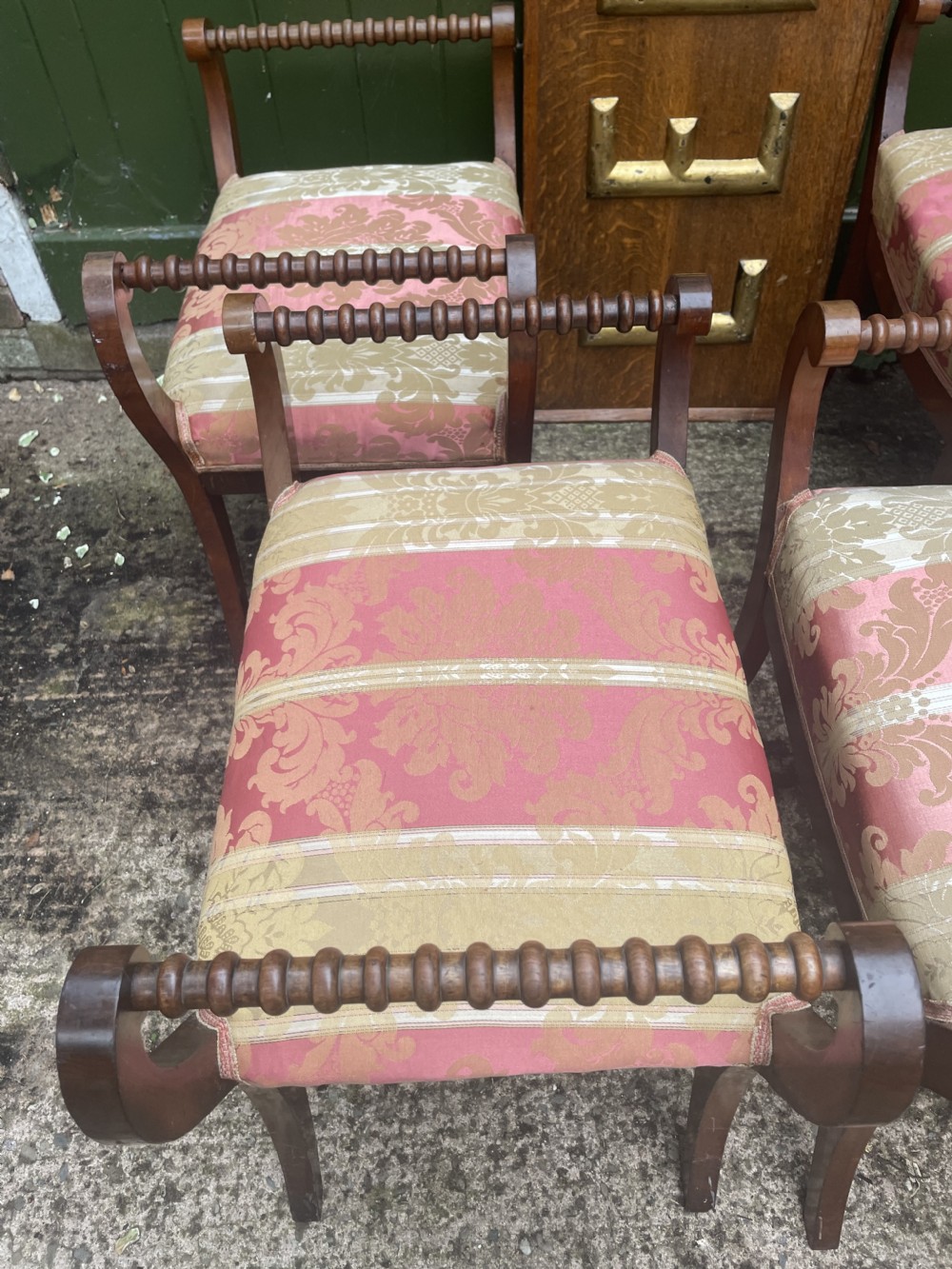 Set of four early nineteenth-century mahogany dressing stools with raised spiral-turned handles, swept legs, and red and gold patterned damask seats. View XXI