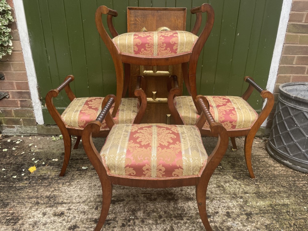Set of four early nineteenth-century mahogany dressing stools with raised spiral-turned handles, swept legs, and red and gold patterned damask seats. View XVI