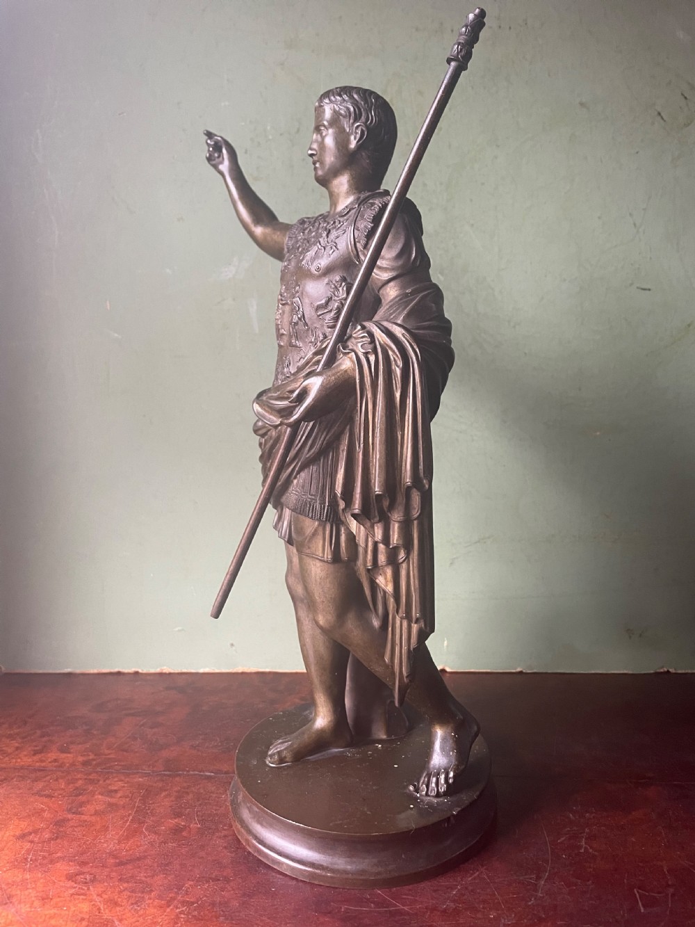 A late nineteenth-century dark bronze sculpture depicting Emperor Augustus of Prima Porta standing in classical armor with his right arm raised. View II