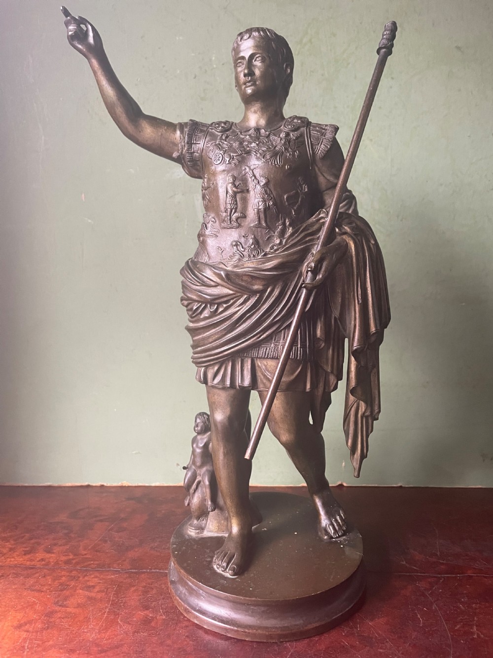 A late nineteenth-century dark bronze sculpture depicting Emperor Augustus of Prima Porta standing in classical armor with his right arm raised. View III