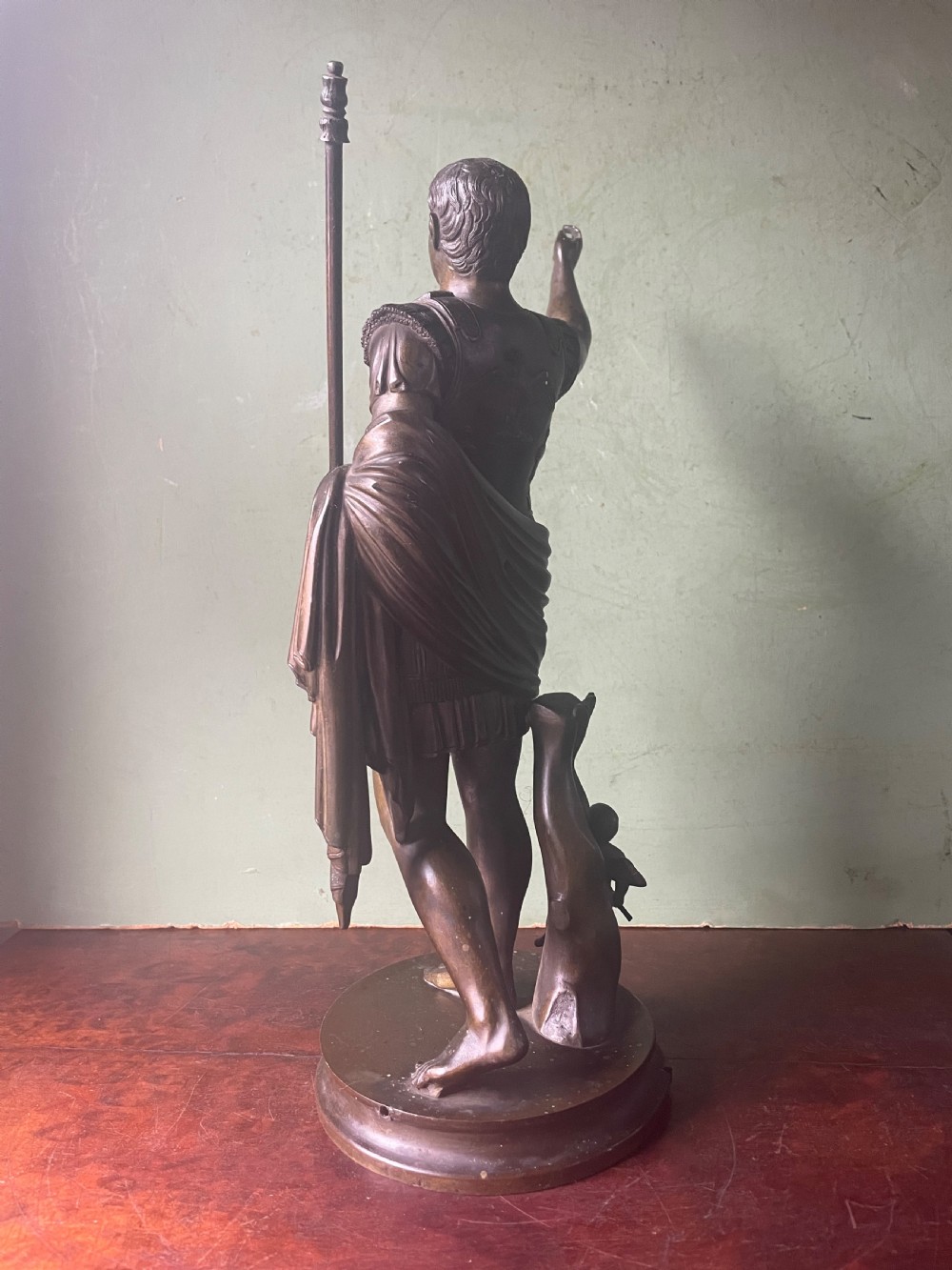 A late nineteenth-century dark bronze sculpture depicting Emperor Augustus of Prima Porta standing in classical armor with his right arm raised. View V