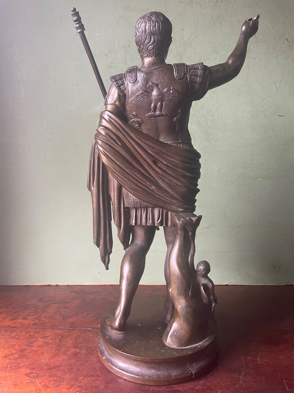 A late nineteenth-century dark bronze sculpture depicting Emperor Augustus of Prima Porta standing in classical armor with his right arm raised. View VI