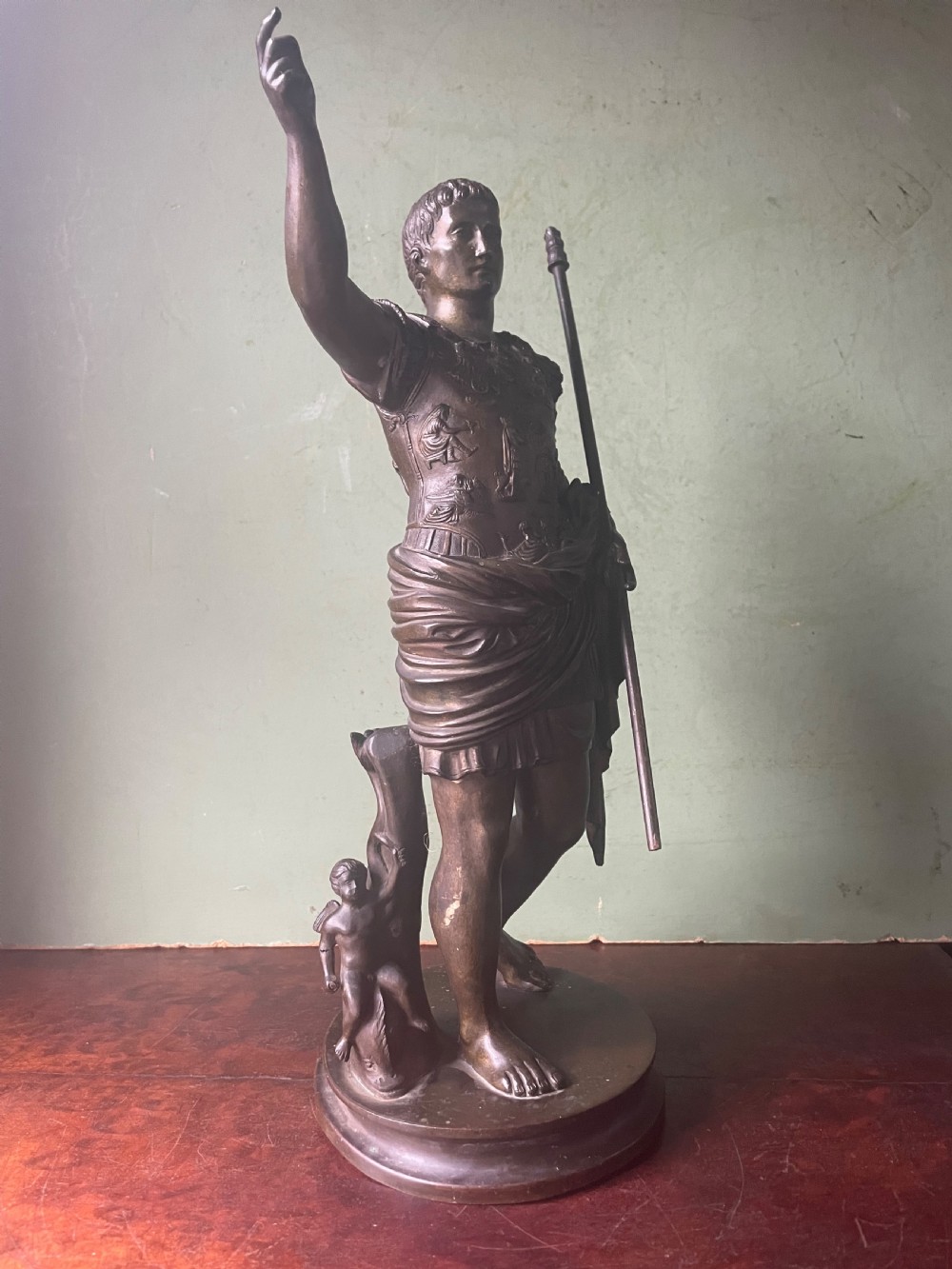 A late nineteenth-century dark bronze sculpture depicting Emperor Augustus of Prima Porta standing in classical armor with his right arm raised. View VII