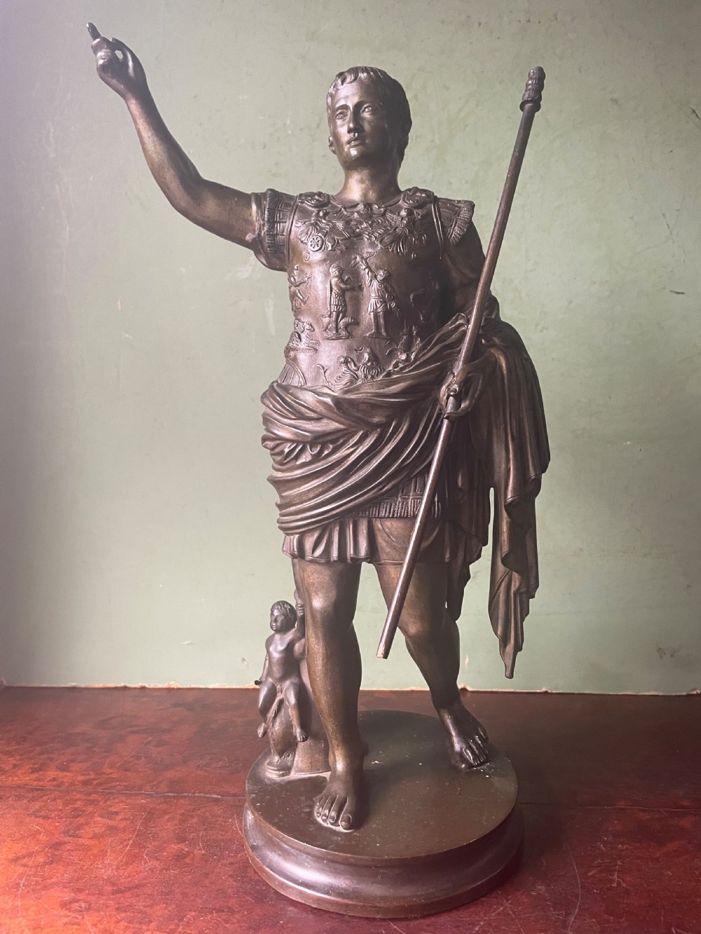 A late nineteenth-century dark bronze sculpture depicting Emperor Augustus of Prima Porta standing in classical armor with his right arm raised. View XI