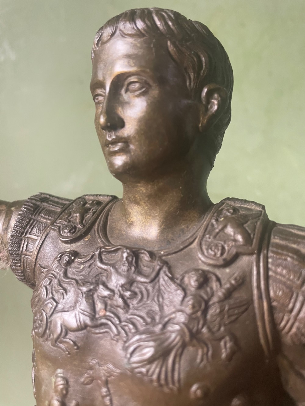 A late nineteenth-century dark bronze sculpture depicting Emperor Augustus of Prima Porta standing in classical armor with his right arm raised. View XII