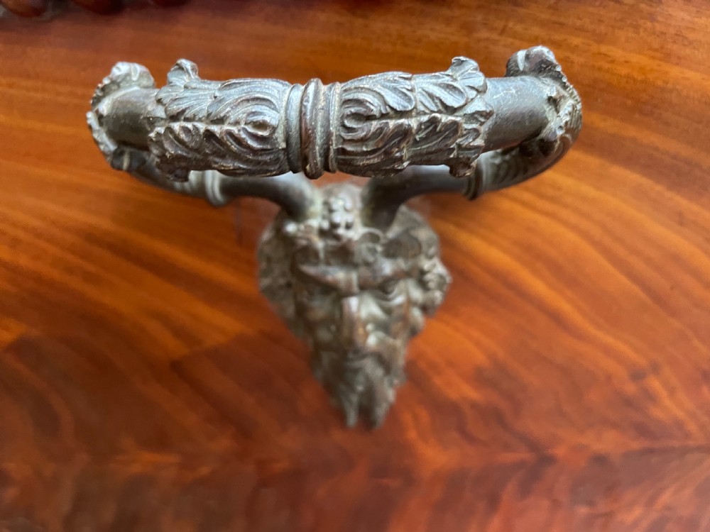 A George IV open mahogany wine cooler of classical sarcophagus form featuring flame mahogany veneer panels and carved bead moulding. View XV