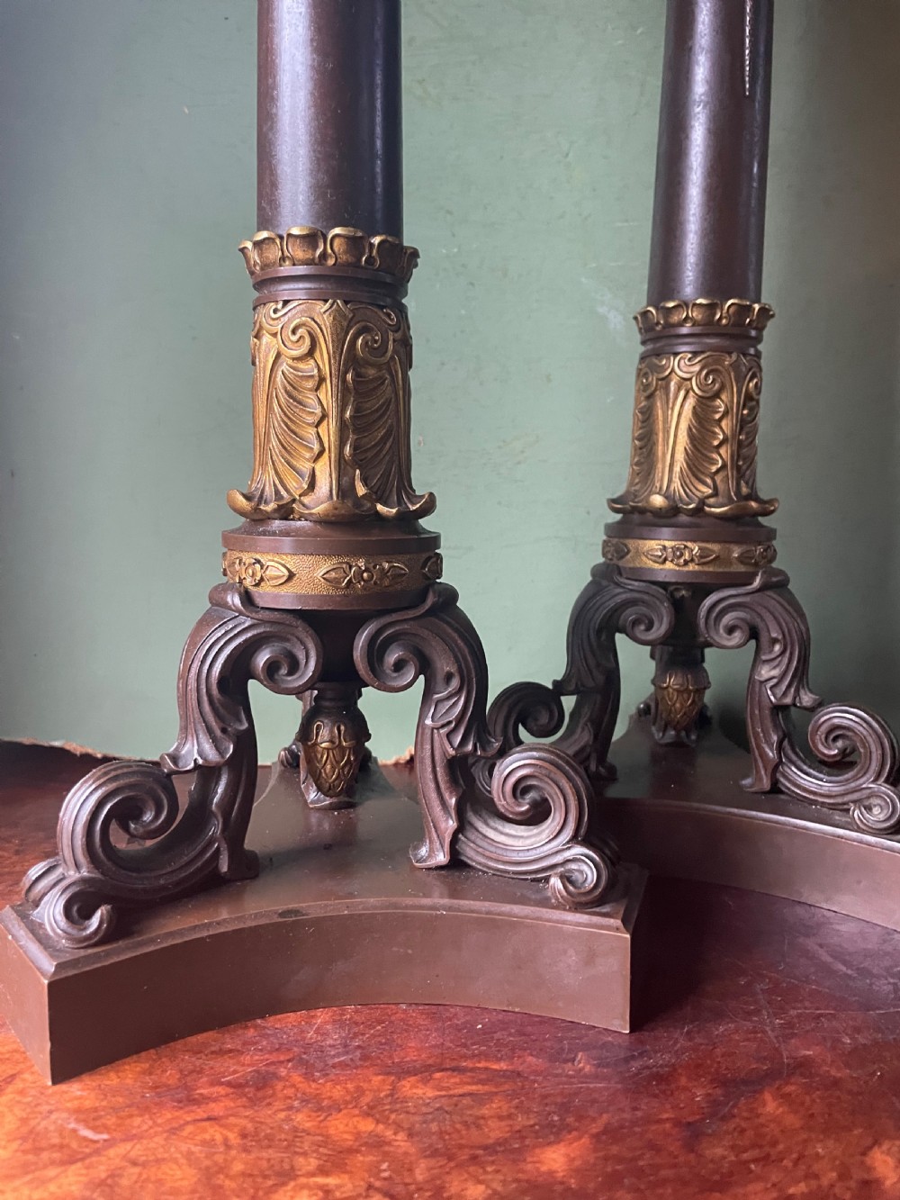 A pair of early nineteenth-century French Restauration patinated bronze and ormolu candelabras with serpent-entwined columns and scroll bases. View II