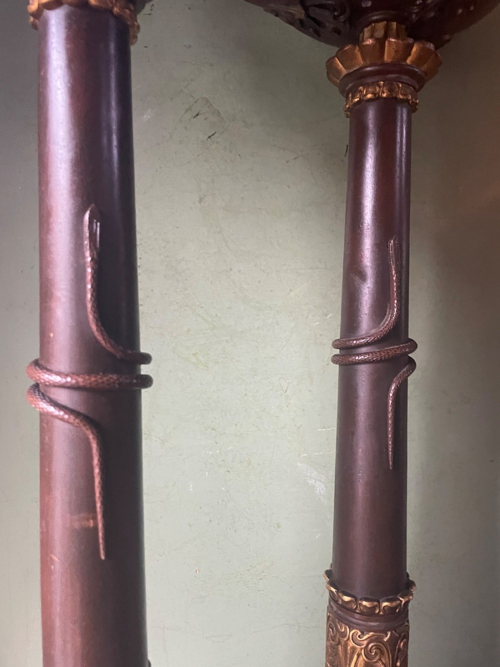 A pair of early nineteenth-century French Restauration patinated bronze and ormolu candelabras with serpent-entwined columns and scroll bases. View III