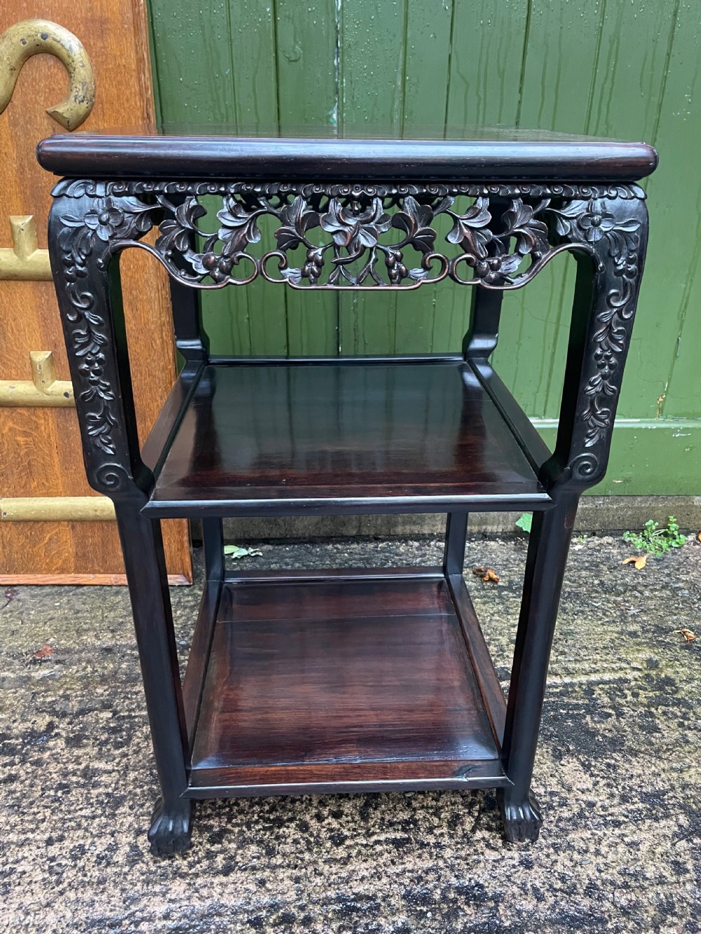 A late nineteenth-century Chinese square dark hardwood two-tier side table featuring intricately carved floral openwork aprons and lower shelf tiers. View III