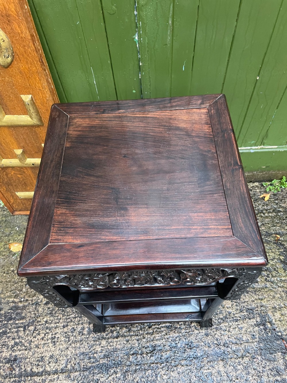 A late nineteenth-century Chinese square dark hardwood two-tier side table featuring intricately carved floral openwork aprons and lower shelf tiers. View VII