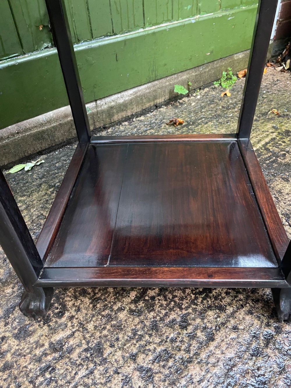 A late nineteenth-century Chinese square dark hardwood two-tier side table featuring intricately carved floral openwork aprons and lower shelf tiers. View VIII