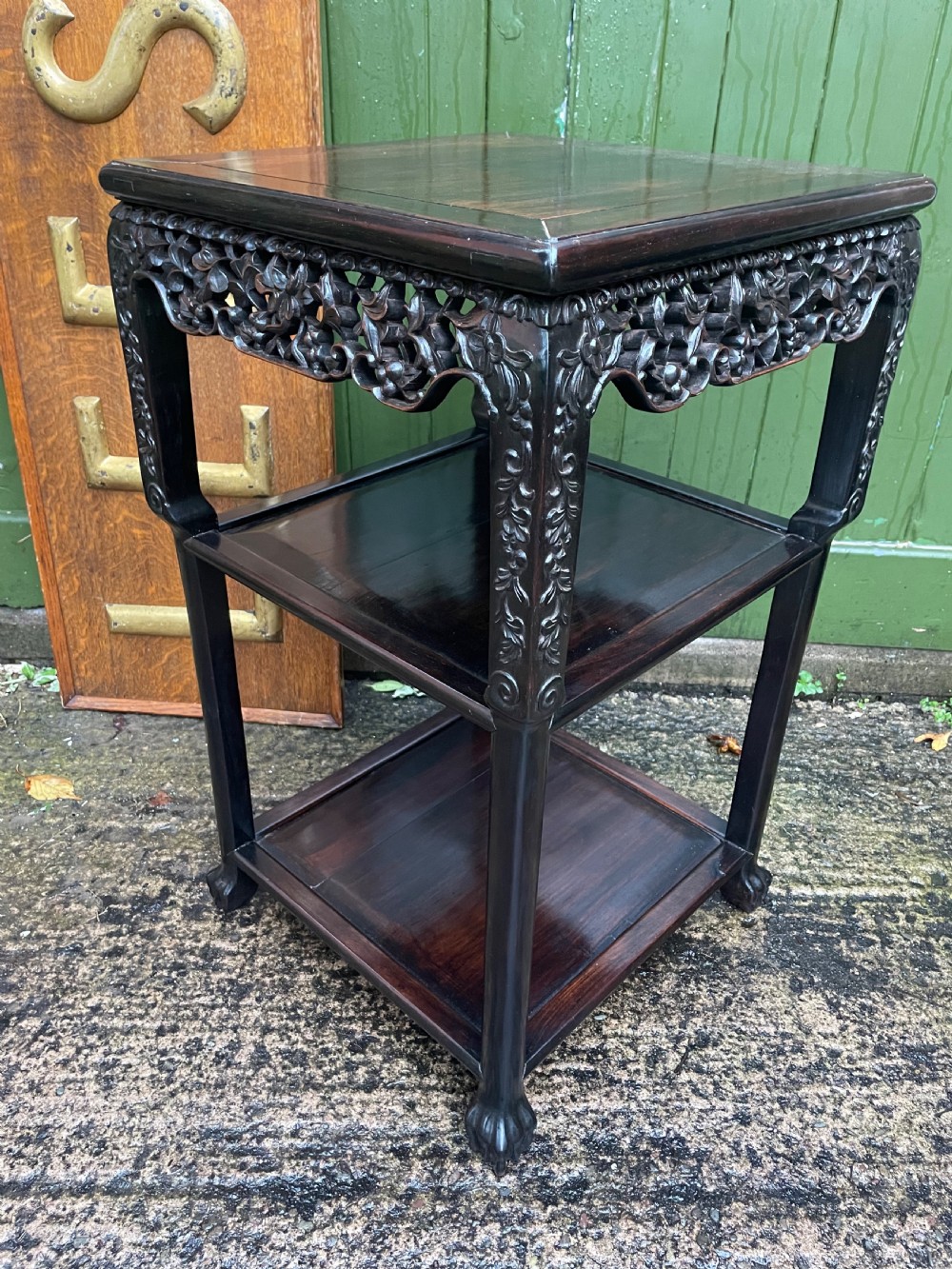 A late nineteenth-century Chinese square dark hardwood two-tier side table featuring intricately carved floral openwork aprons and lower shelf tiers. View XI