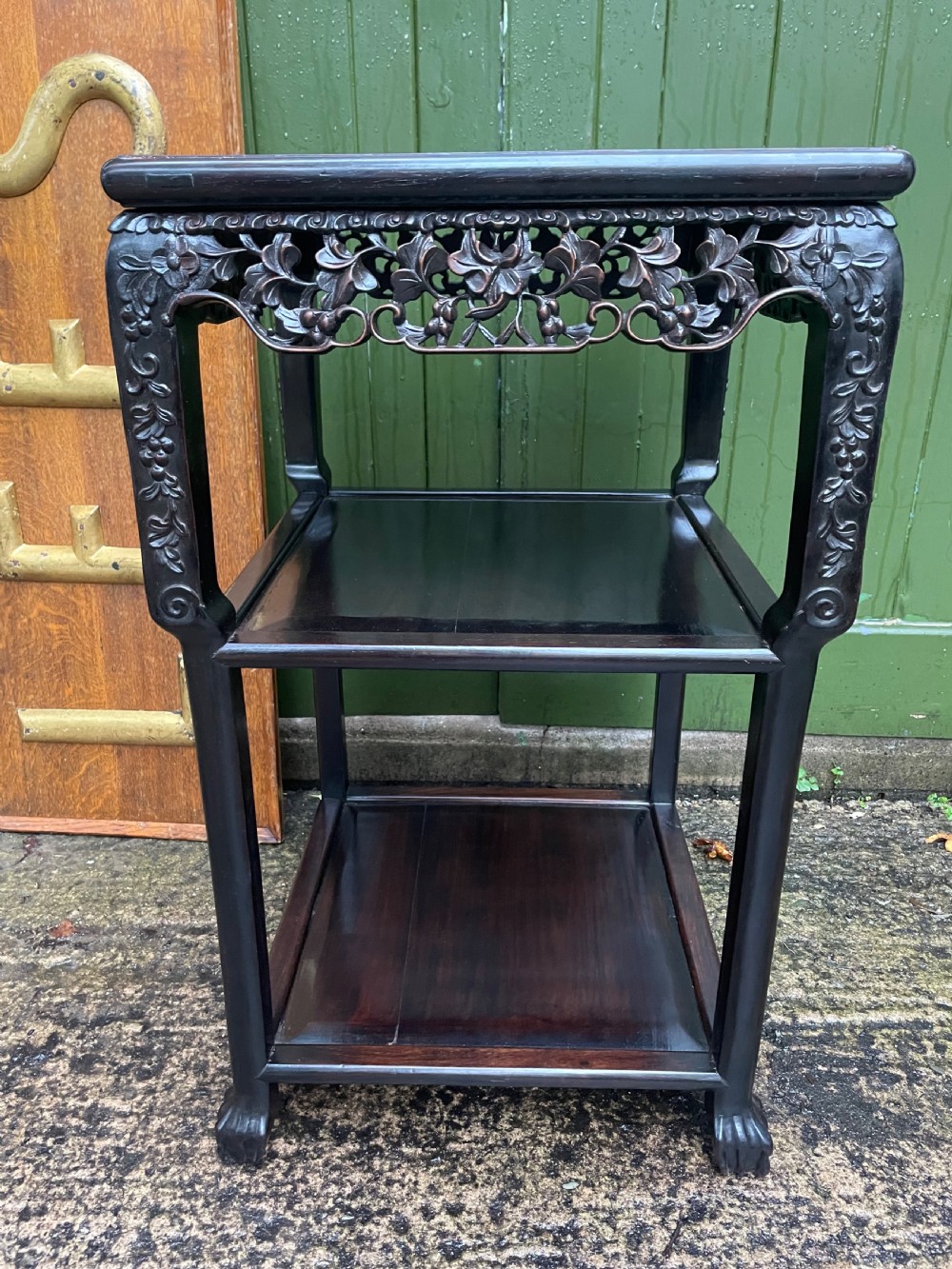 A late nineteenth-century Chinese square dark hardwood two-tier side table featuring intricately carved floral openwork aprons and lower shelf tiers. View XII