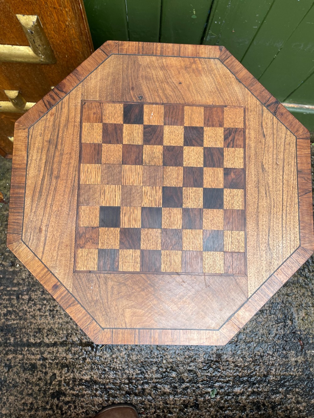 An early nineteenth-century Regency octagonal rosewood games table with a chequerboard inlaid top, brass mounts, and a tripod base. View VIII
