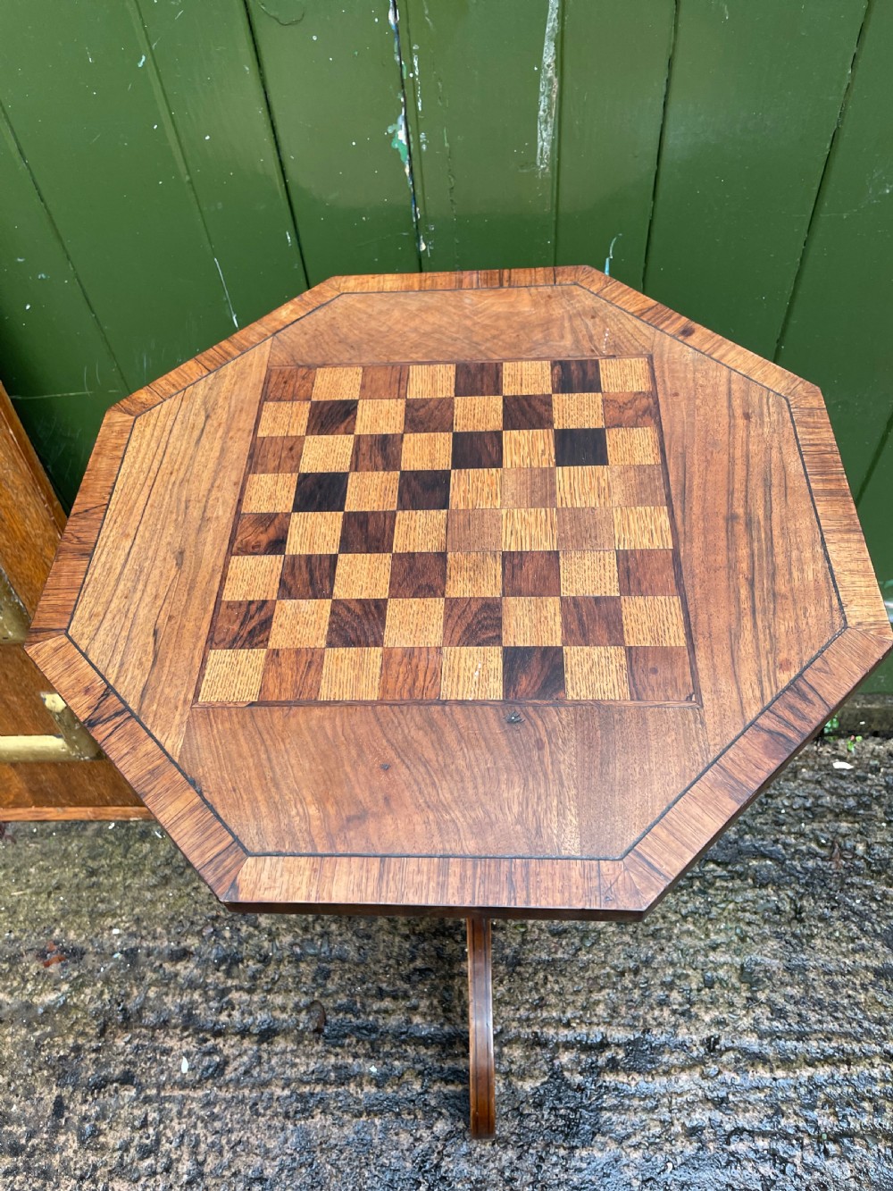 An early nineteenth-century Regency octagonal rosewood games table with a chequerboard inlaid top, brass mounts, and a tripod base. View XIV