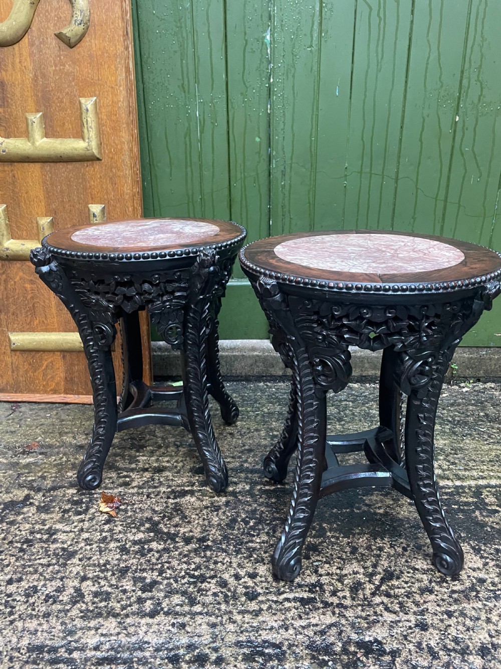 A pair of circular late nineteenth-century Chinese hardwood stands featuring inset pinkish rouge marble tops and intricately carved aprons and legs. View III