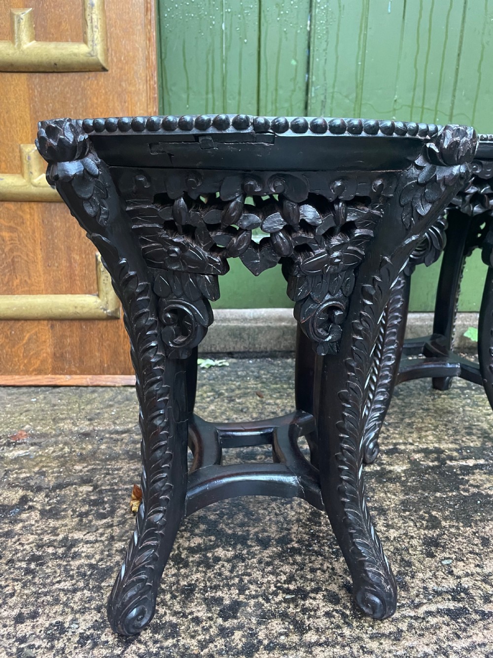 A pair of circular late nineteenth-century Chinese hardwood stands featuring inset pinkish rouge marble tops and intricately carved aprons and legs. View VII