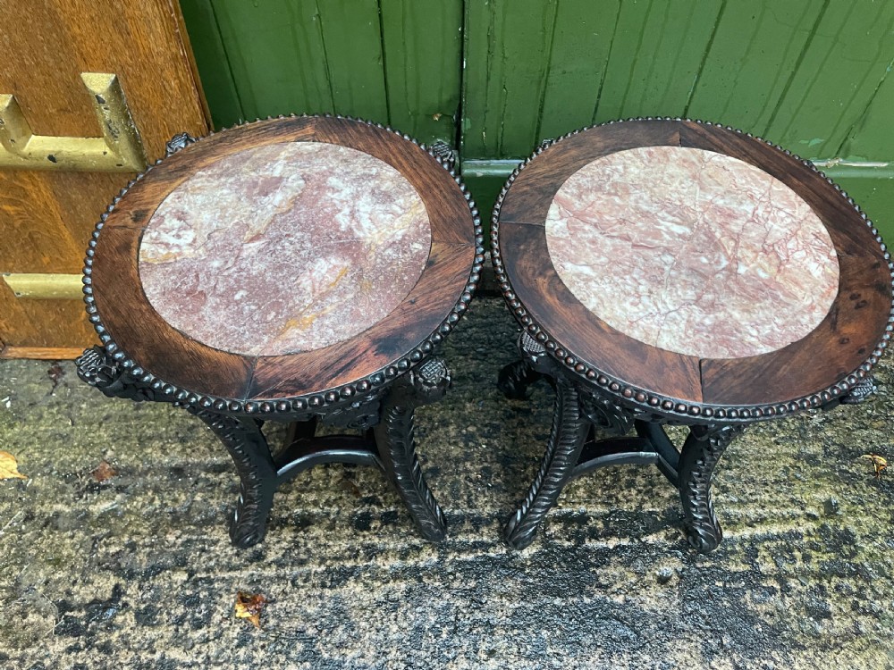 A pair of circular late nineteenth-century Chinese hardwood stands featuring inset pinkish rouge marble tops and intricately carved aprons and legs. View XI