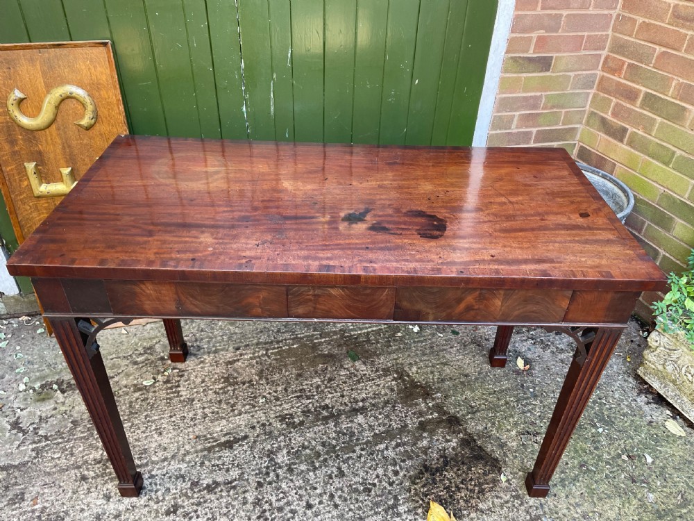 A late 18th-century George III mahogany pier table featuring fluted legs, carved corner brackets, and a rectangular polished top. View III