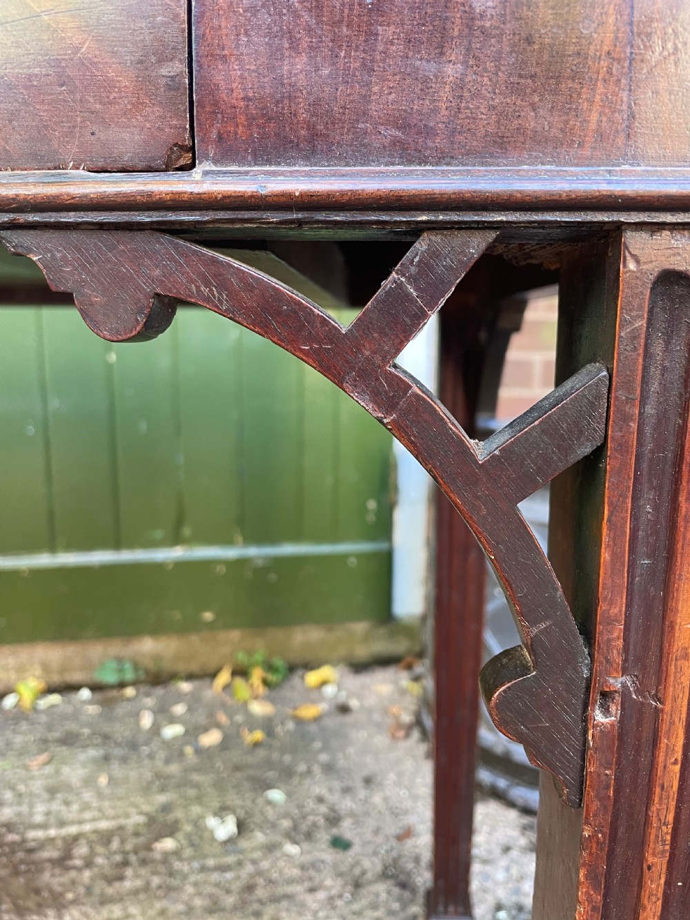 A late 18th-century George III mahogany pier table featuring fluted legs, carved corner brackets, and a rectangular polished top. View IV