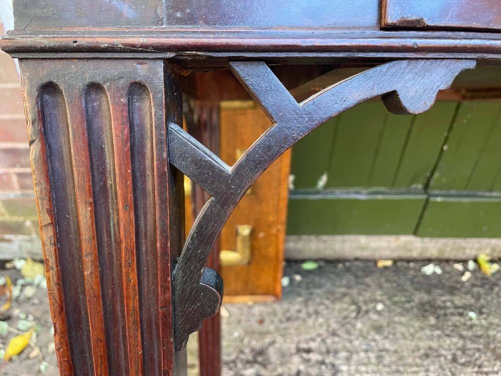 A late 18th-century George III mahogany pier table featuring fluted legs, carved corner brackets, and a rectangular polished top. View XII