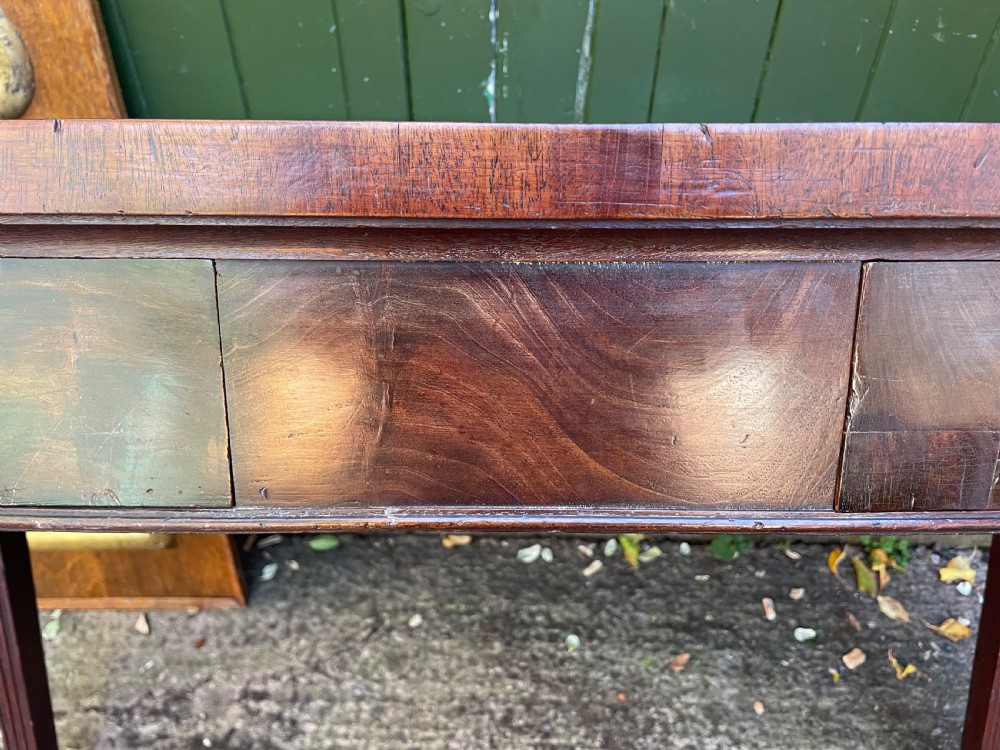 A late 18th-century George III mahogany pier table featuring fluted legs, carved corner brackets, and a rectangular polished top. View XIV